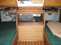 Aft view of 23/IV interior showing optional shore power panel, stereo and speakers