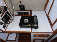 The helm, when converted to counter space, easily holds a stovetop for cooking