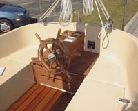 Steering station, standard teak wheel, and storage underneath