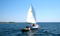 Sun Cat under sail and towing dinghy on Georgian Bay